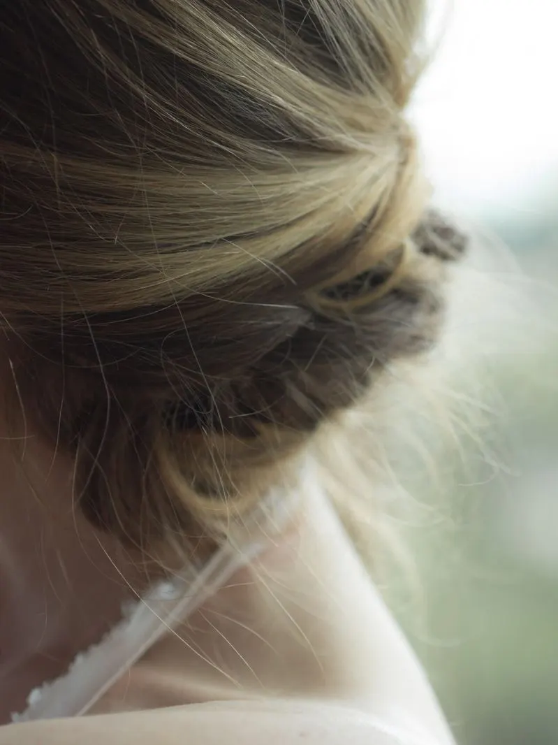 A loose, undone twist for hair that still moves — the studio's most-requested wedding-guest look.